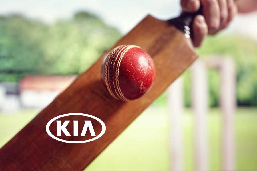 kiaportfoliofeatured Cricket bat and red ball with Kia branding